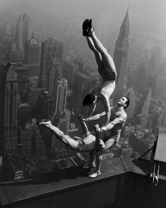 acrobats on steel frame skyscraper