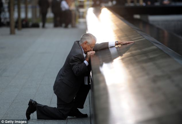 Robert Peraza kneeling at 911 Memorial