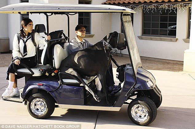 Giant George riding with a Japanese reporter in golf cart