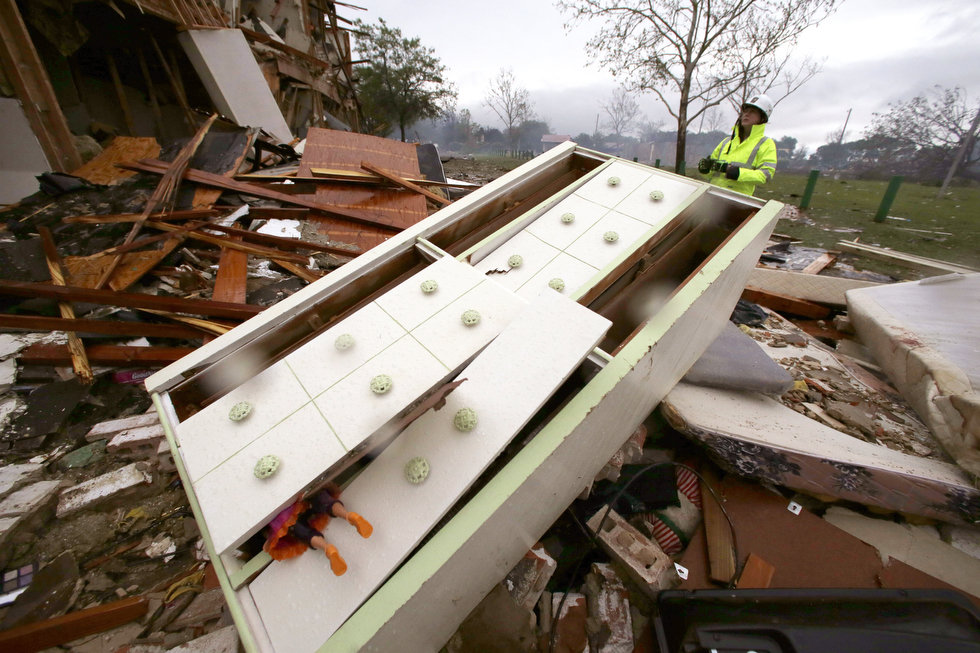 Note the doll hanging out of the dresser which was blown from an apartment. (AP Photo/LM Otero) Source 