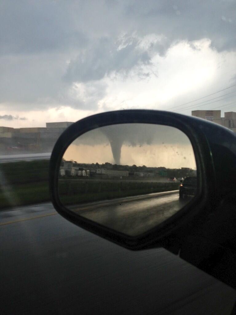 I'll bet this guy was glad to see the Moore tornado in his rear-view mirror rather than out his front windshield.