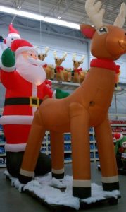 Store display Santa behind Rudolf.