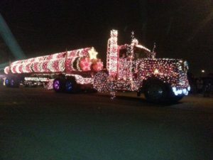 Semi-truck covered with Christmas lights.