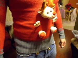 A stuffed reindeer looks like it's coming out of the man's belly.